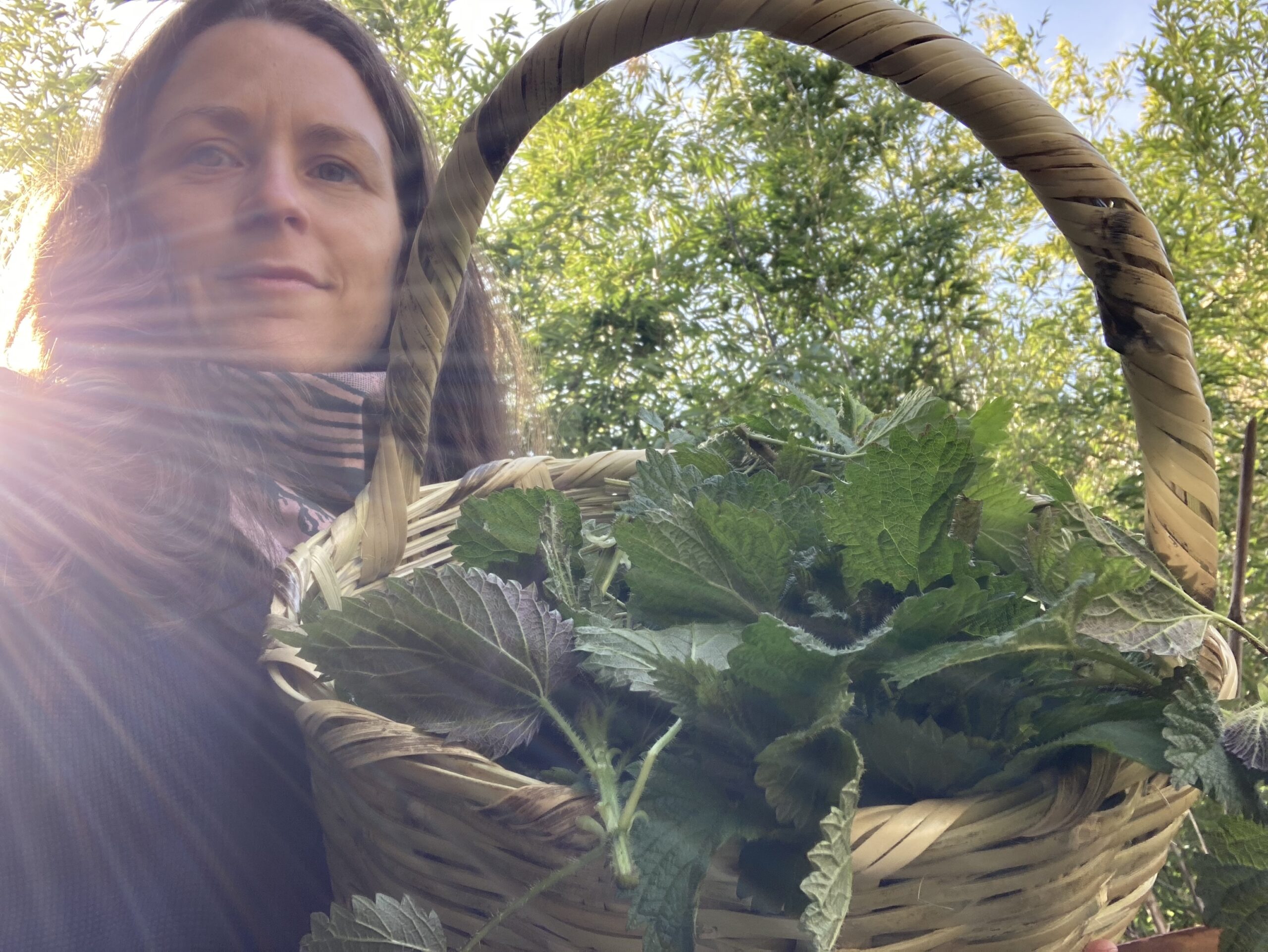 Close up image of Rosa holding a basket of nettles